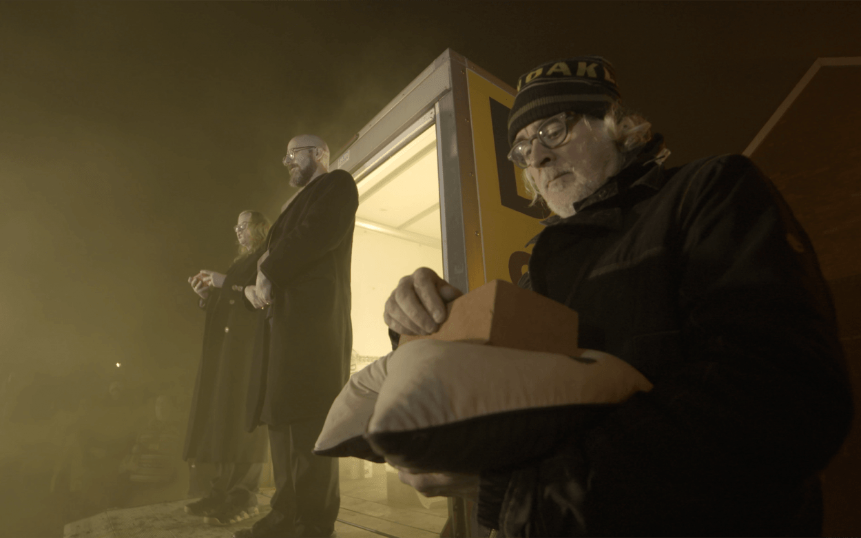 Jimmy Cauty holds the brick with his brother's ashes