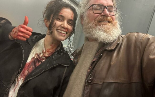 Paul Duane the film director posing with actress Simone Collins still in costume with his magnificent beard